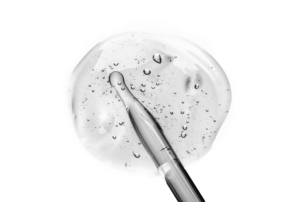 skincare dropper showing retinol coming out of the bottle