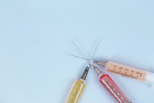 Colorful needles representing Botox, Dermal Fillers, and Microneedling treatments.