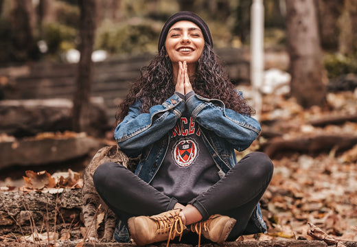 Young woman meditating in nature, symbolizing holistic skin and microbiome health