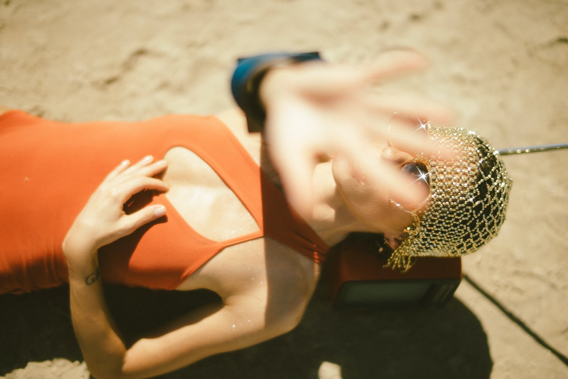 Woman resting, shielding her face, highlighting skincare concerns from viral beauty trends