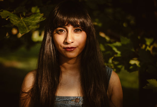 Indian woman with greenery, symbolizing the link between skin health and the microbiome