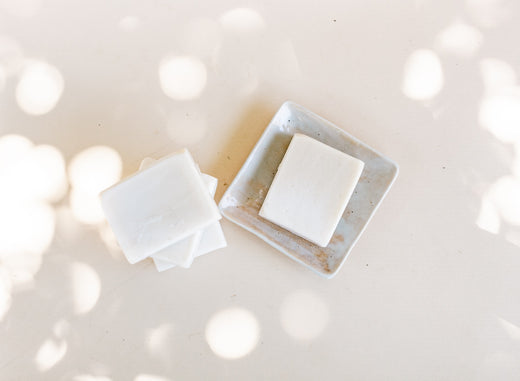 White bar of soap with sunspots, symbolizing clean beauty and transparency.