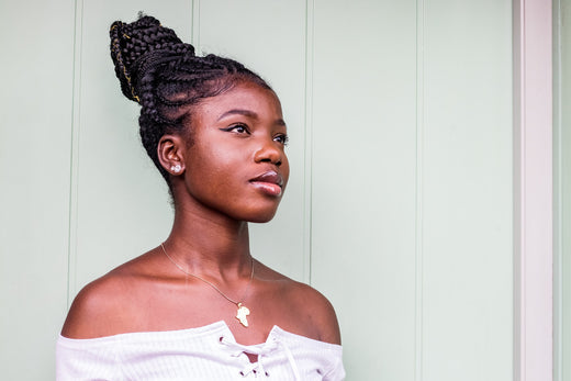 Young Black woman with glowing, healthy skin after using probiotics.