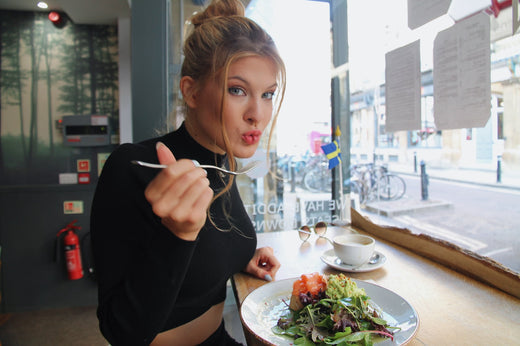 Woman enjoying a healthy salad to support microbiome health