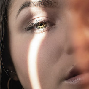 Close-up of glowing face with sunlight streaming in.