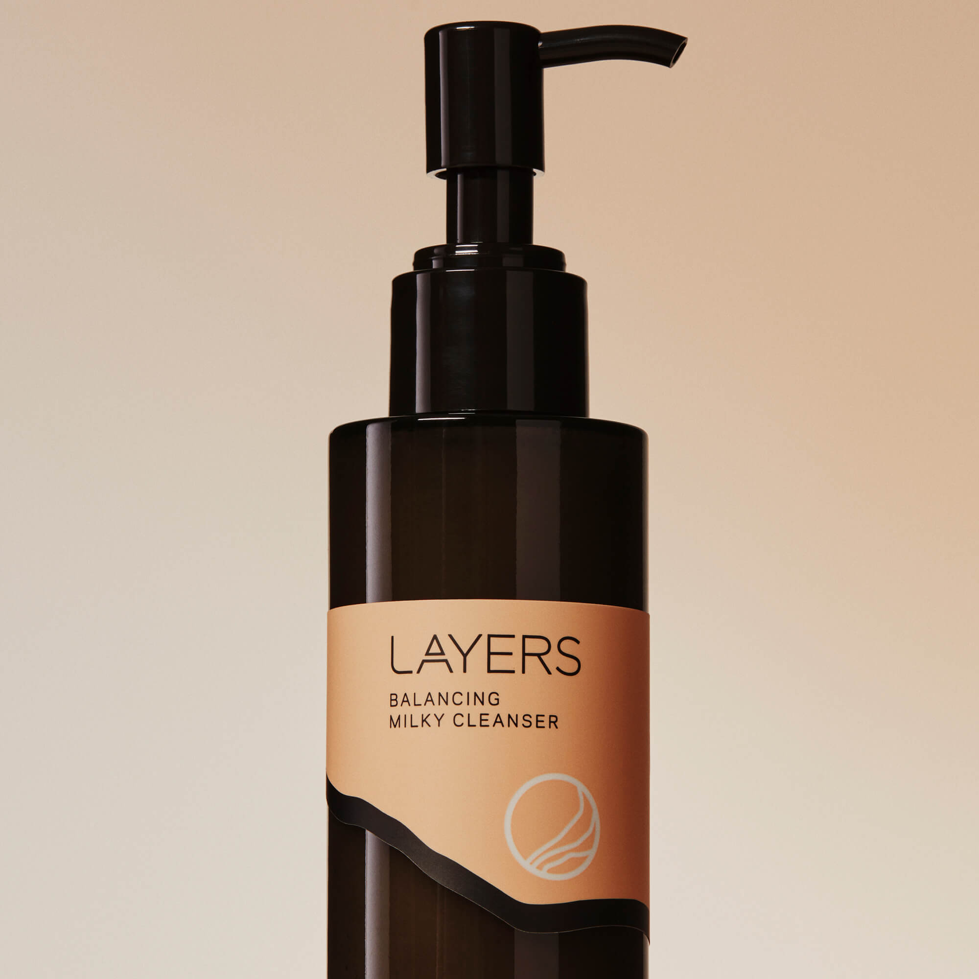 Layers Probiotic Skincare Balancing Milky Cleanser in semi-transparent black glass bottle with pump. For dry, oily, and combination skin. 