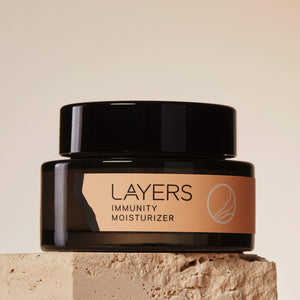Layers Probiotic Skincare Immunity Moisturizer in semi-transparent black glass jar. For dry, oily, and combination skin. 